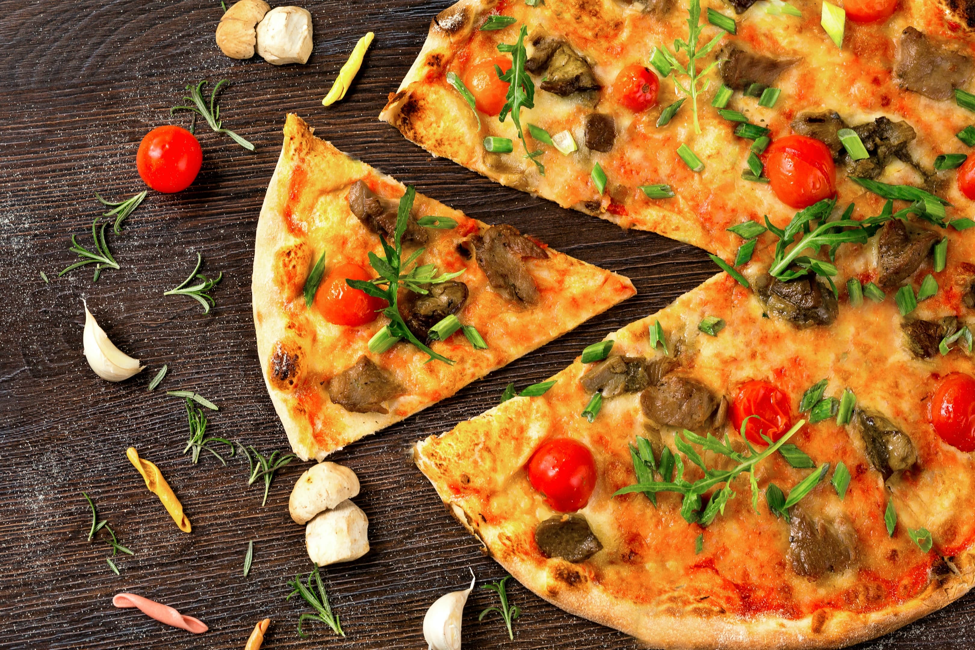 Photo of a pizza on a wooden board.